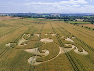 Aerial view of an intricate geometric crop circle formation in a wheat field near Etchilhampton and Devizes in Wiltshire, England, UK