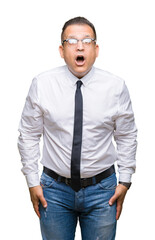 Middle age bussines arab man wearing glasses over isolated background afraid and shocked with surprise expression, fear and excited face.