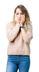 Beautiful young blonde woman wearing sweatershirt over isolated background Tired hands covering face, depression and sadness, upset and irritated for problem