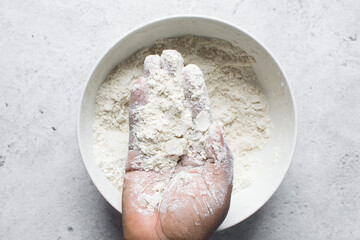 butter and flour being mixed together, butter and flour mixed into rough pastry, butter and flour being used to make cookie dough or pie dough, process of making cut out sugar cookies