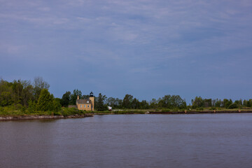 An old brick lighthouse scenic landscape along Great Lake Superior.