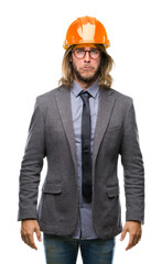 Young handsome architec man with long hair wearing safety helmet over isolated background depressed and worry for distress, crying angry and afraid. Sad expression.