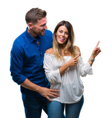 Young couple in love over isolated background smiling and looking at the camera pointing with two hands and fingers to the side.