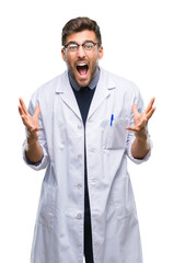 Young handsome man wearing doctor, scientis coat over isolated background crazy and mad shouting and yelling with aggressive expression and arms raised. Frustration concept.