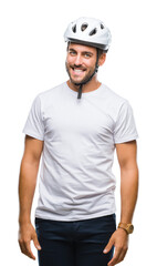 Young handsome man wearing cyclist safety helmet over isolated background looking away to side with smile on face, natural expression. Laughing confident.