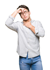 Young handsome man wearing glasses over isolated background Touching forehead for illness and...
