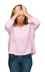 Beautiful middle age adult woman wearing winter sweater over isolated background suffering from headache desperate and stressed because pain and migraine. Hands on head.