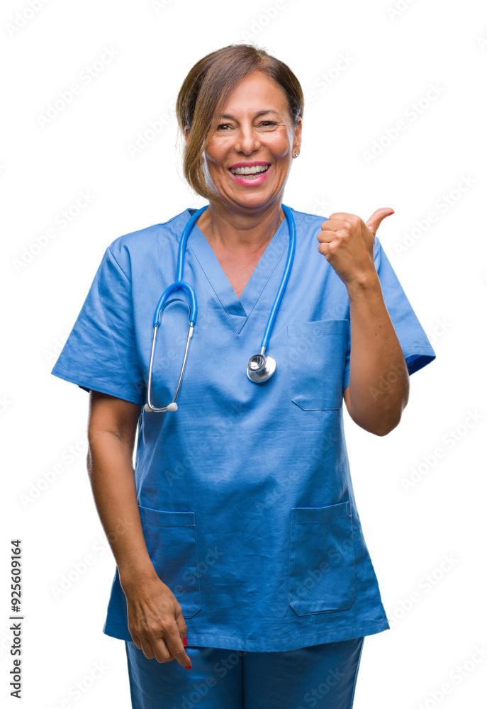 Canvas Prints Middle age senior nurse doctor woman over isolated background smiling with happy face looking and pointing to the side with thumb up.