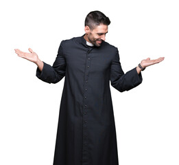 Young Christian priest over isolated background Smiling showing both hands open palms, presenting...