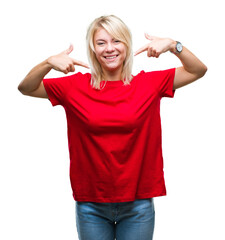 Young beautiful blonde woman wearing red t-shirt over isolated background smiling confident showing and pointing with fingers teeth and mouth. Health concept.