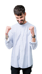 Naklejka premium Young handsome business man over isolated background very happy and excited doing winner gesture with arms raised, smiling and screaming for success. Celebration concept.