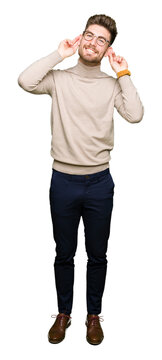 Young handsome business man wearing glasses Smiling pulling ears with fingers, funny gesture. Audition problem