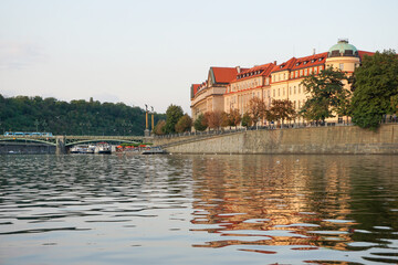 View of buildings by river against clear sky