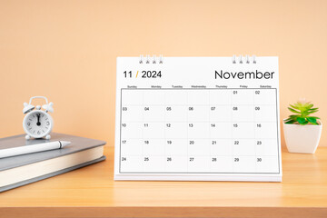 November 2024, Monthly desk calendar for 2024 year on wooden table.