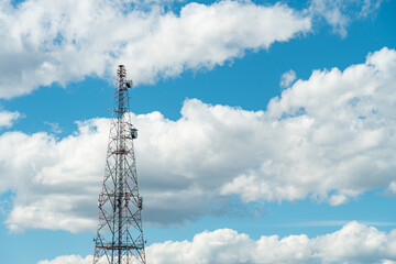Mobile phone communication radio antenna, 3G, 4G, 5G, 6G. Antenna over cloudy blue sky at summer....