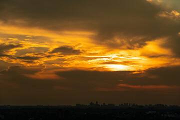 Fototapeta premium Sunset cityscape. Amazing red orange evening clouds and sun in the American city. Cloudscape summer nature. Clean of birds, bugs, and dust.