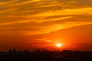Fototapeta premium Sunset cityscape. Evening clouds and sun in the American city. Cloudscape summer nature. Clean of birds, bugs, and dust.
