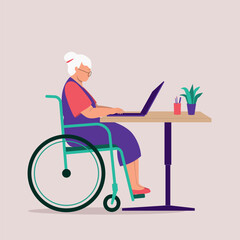 Side View Of A Disabled Elderly Woman In Wheelchair Using Laptop At The Desk.