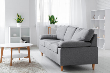 Comfortable sofa and coffee table in interior of living room