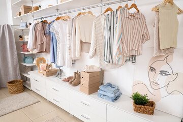 Interior of stylish boutique with clothes and shoes