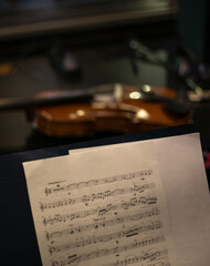 musical score with a violin in the background - recording studio © Baudalab