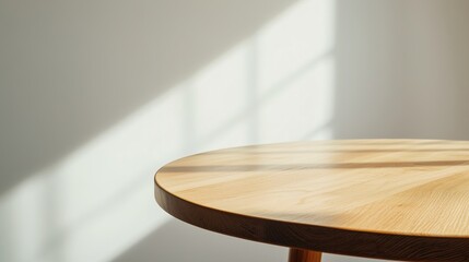 A wooden table illuminated by gentle sunlight, showcasing its clean lines and natural texture. Perfect for design projects emphasizing warmth and simplicity.