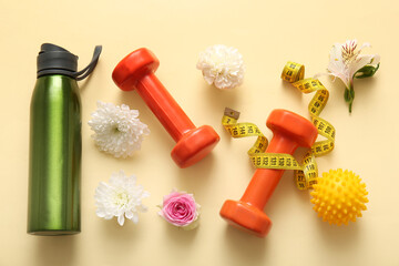 Composition with sports equipment, bottle of water and flowers on color background