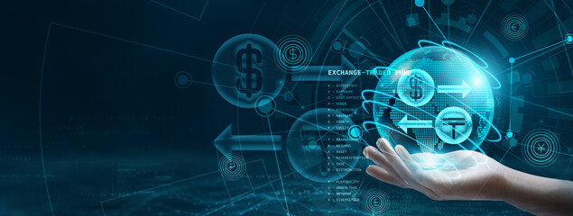 Hand holding an ETF, which is an exchange-traded fund, globe with network connecting data. Representation of digital technology, where ETFs can provide exposure to diversified markets and sectors.