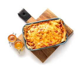Wooden board with tasty enchilada and spices on white background