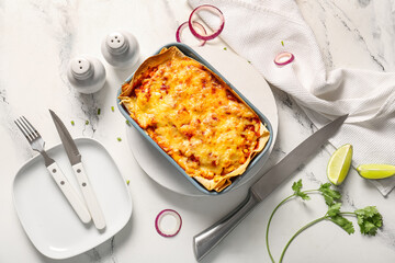 Composition with tasty enchilada, spices and cutlery on light background