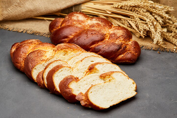 Braided sweet bread loaf sliced, showcasing its golden crust and soft, fluffy interior