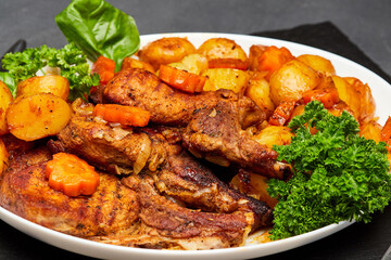 Juicy pork steak on the bone with roasted vegetables, perfect for a hearty meal