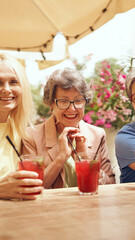 A Joyful and Delightful Gathering Over Refreshing Drinks in a Beautiful Sunny Setting