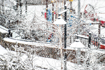 Snow falls gently on a wintery park scene, evoking the spirit of the New Year and seasonal tranquility.