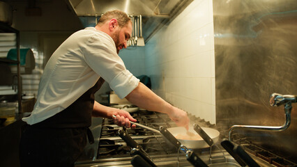 Chef Completing The Cooking Of The Dish