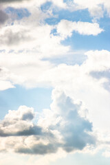 Vertical background featuring clouds with light beams breaking through, offering a peaceful and contemplative space for text, representing hope and possibilities.