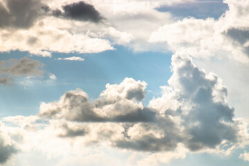Horizontal background with clouds and light beams shining through, creating a serene and hopeful atmosphere, ideal for text placement and evoking inspiration and clarity.