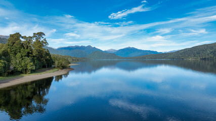 Aerial footage of the alpine lake surrounded by the Southern Alps mountain range