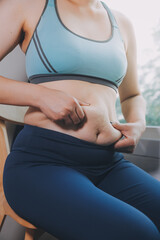 fat woman, fat belly, chubby, obese woman hand holding excessive belly fat with measure tape, woman diet lifestyle concept