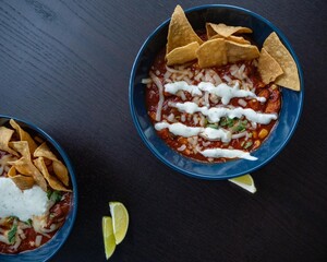 Mexican pork stew with lime on dark background