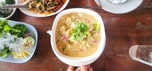 Crab dipping sauce served on table with fresh vegetables. stew coconut milk with herbs such as onions, lemongrass. Coconut Paste with Crab Meat and Fresh Vegetable. Popular Thai cuisine. Healthy food
