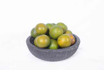 Green orange fruit or Tangerine orange with half slice and green leaves in Traditional Mortar isolated on white background.