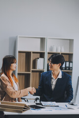 Entrepreneur Asian businessman and businesswoman discussing new business project in tablet in modern Meeting In Modern Office, Asian business casual concept.