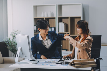 Entrepreneur Asian businessman and businesswoman discussing new business project in tablet in modern Meeting In Modern Office, Asian business casual concept.