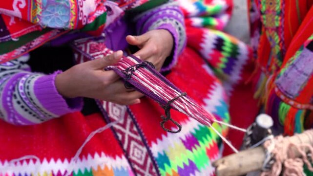hands of peruvian woman weaving in Cusco Per&uacute; with traditional costume
