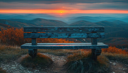 Bench overlooking sunrise over mountains