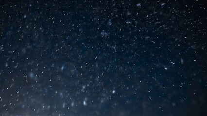 Obraz premium Snow is falling on blue night background from the starry sky on New Year's Eve