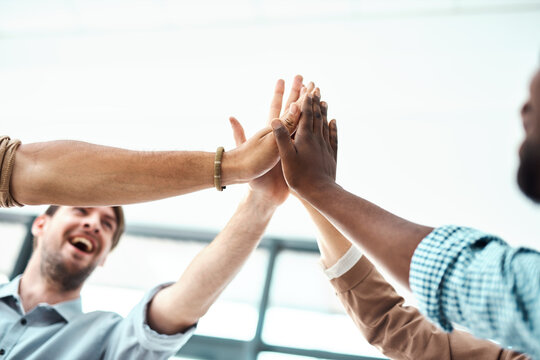 Business people, hands and high five for teamwork, partnership or collaboration with celebration or agreement. Group, creative employees and workers for team support, success and diversity in agency