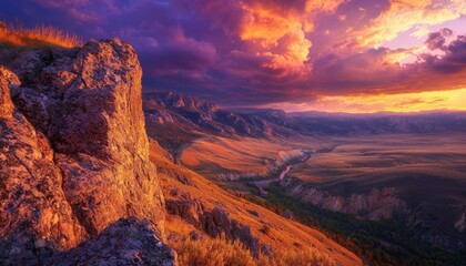 Fototapeta premium Panoramic view of a mountain landscape at sunset during golden hour, with the setting sun casting long shadows across the peaks, the sky ablaze with rich hues of orange, red, and purple, and a river