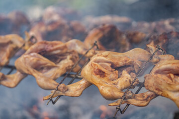 Huli-huli chicken is a grilled chicken dish in Hawaiian cuisine, prepared by barbecuing a chicken over mesquite wood, Oahu Hawaii